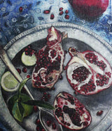 Open pomegranates on plate with spoon